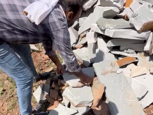 The child was found buried in a stone pile.