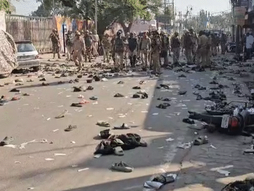 This is the picture after lathicharge. People's shoes and slippers are lying on the road.
