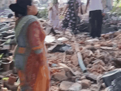 People removing their belongings after breaking the house.