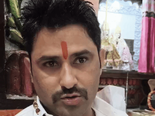 The chief priest of the temple, Pandit Indradeep giving information.