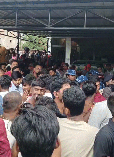A crowd of people gathering at the house of former minister Manju Verma.