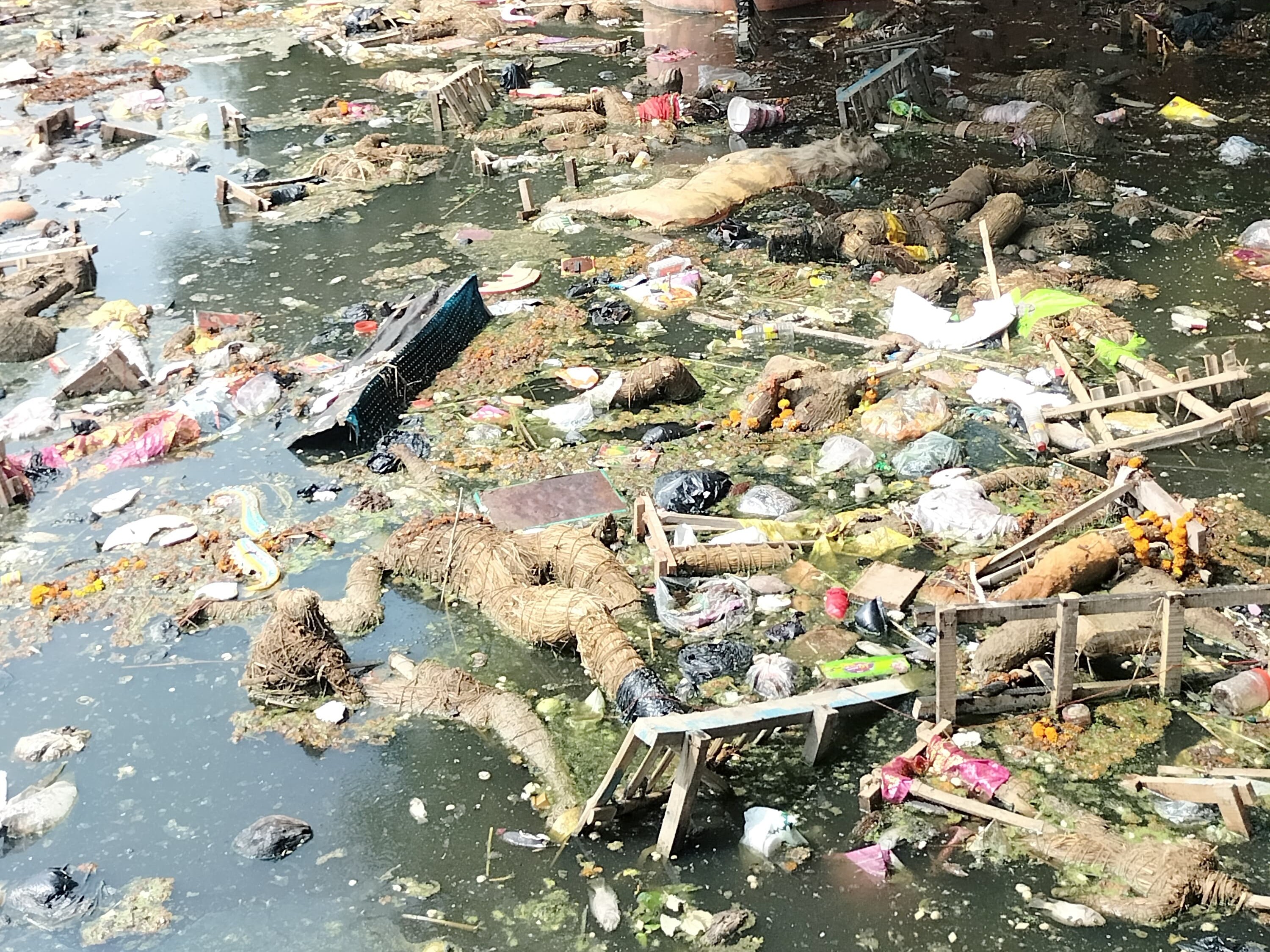 Garbage spread in the historical Khaira temple pond of Gonda