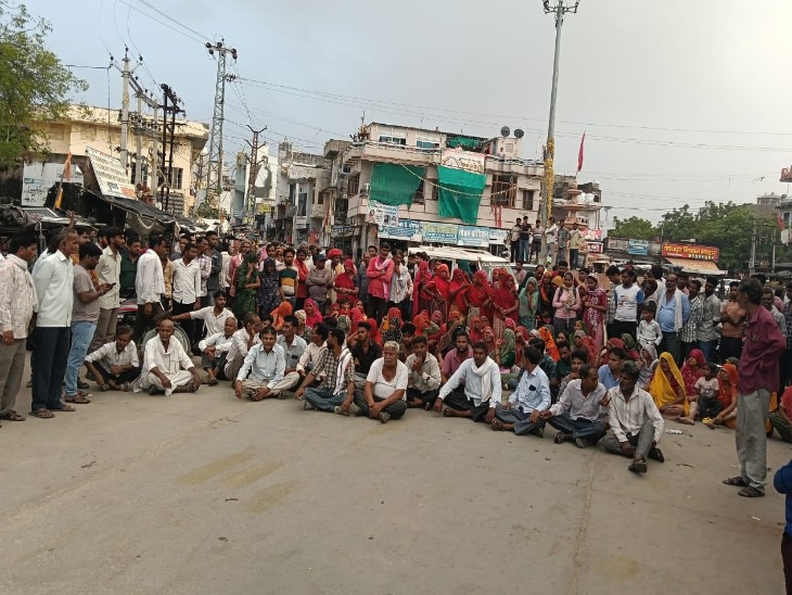 दूनी सरकारी अस्पताल के बाहर तिराहे पर मृतक के परिजन और ग्रामीण रोड जाम कर प्रदर्शन कर रहे हैं।