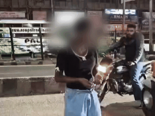 The girl kept dancing in the middle of the road. People kept looking at him.