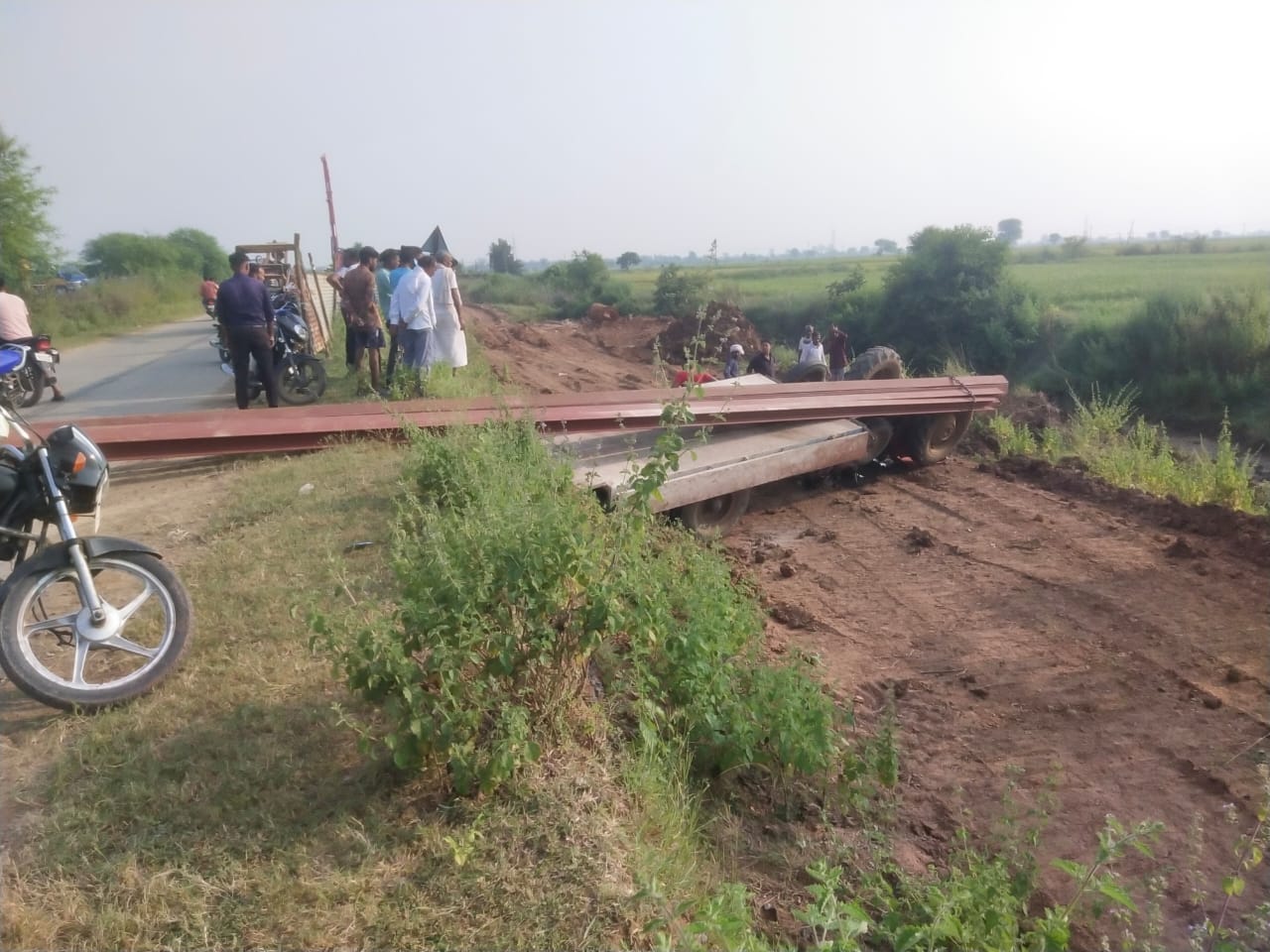 Tractor carrying electric pole overturned, one dead