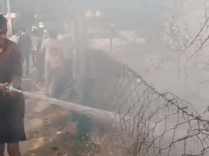 आग बुझाते हुए फायर ब्रिगेड कर्मचारी।