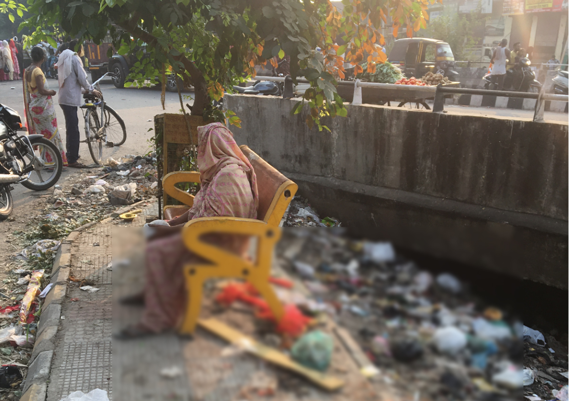 नहर के किनारे गंदगी में बैठी महिला।