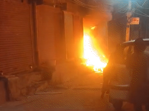 आग लगने पर लोगों ने दुकान के पास खड़ी गाड़ी को धक्का देकर दूर हटाया।