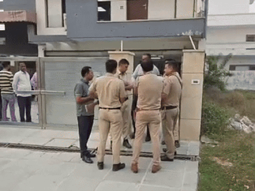 Police officers standing outside the music company's office after the firing.