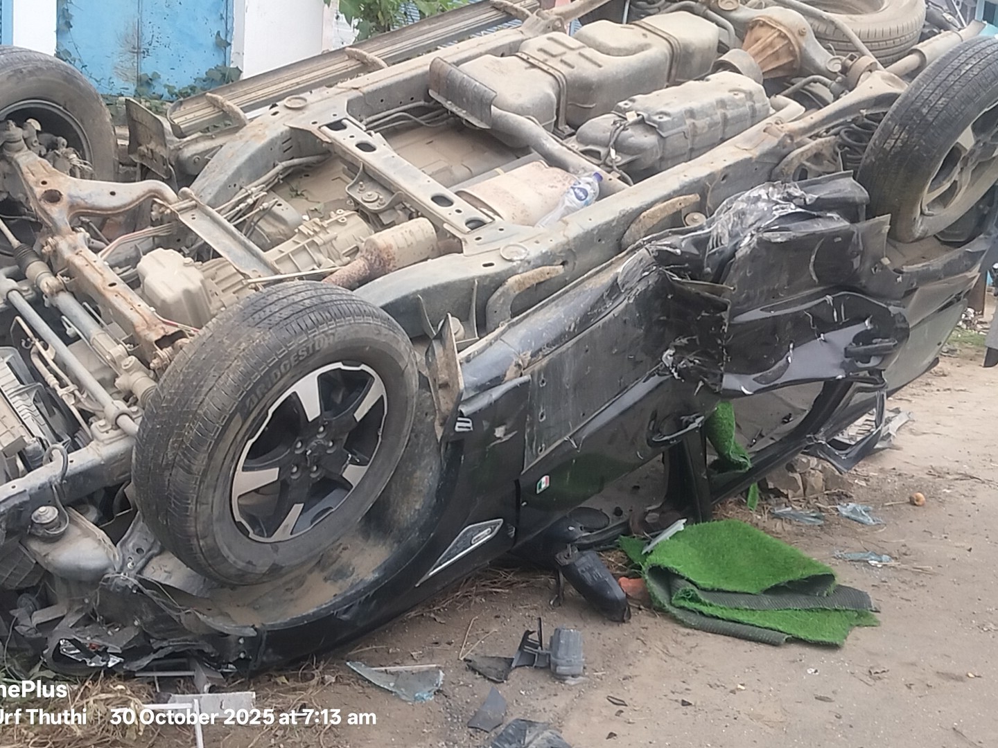 A speeding Scorpio broke the divider and hit the roof of a house.