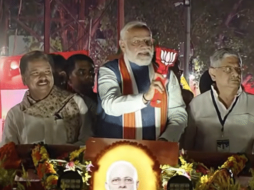 हाथ में पार्टी सिबंल लिए पीएम मोदी ने लोगों का अभिवादन किया।