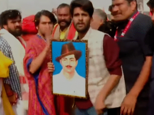 यूपी में पदयात्रा के दूसरे दिन एक भक्त ने धीरेंद्र शास्त्री को भगत सिंह की तस्वीर भेंट की।