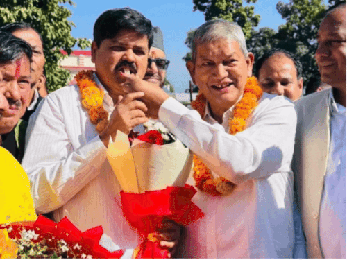 कांग्रेस प्रदेश अध्यक्ष बनने पर गणेश गोदियाल को मिठाई खिलाते पूर्व सीएम हरीश रावत।