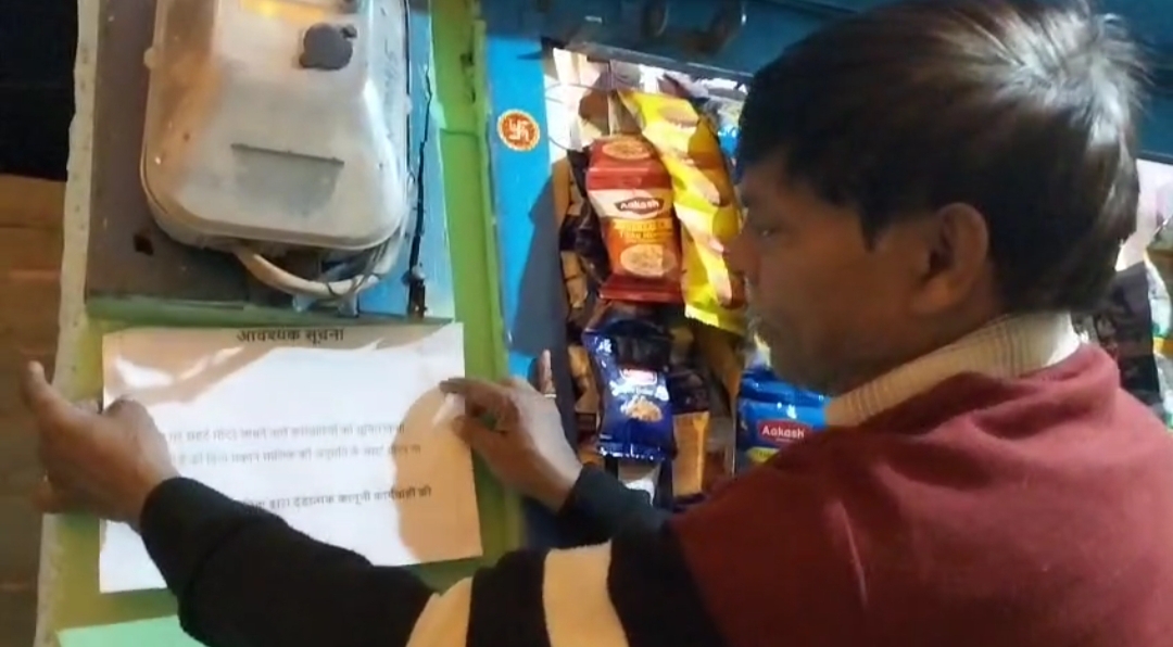 नोटिस चस्पा करते उपभोक्ता।