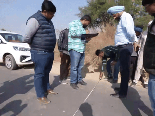 सड़क की पैमाइश करती फ्लाइंग स्क्वॉड की टीम।