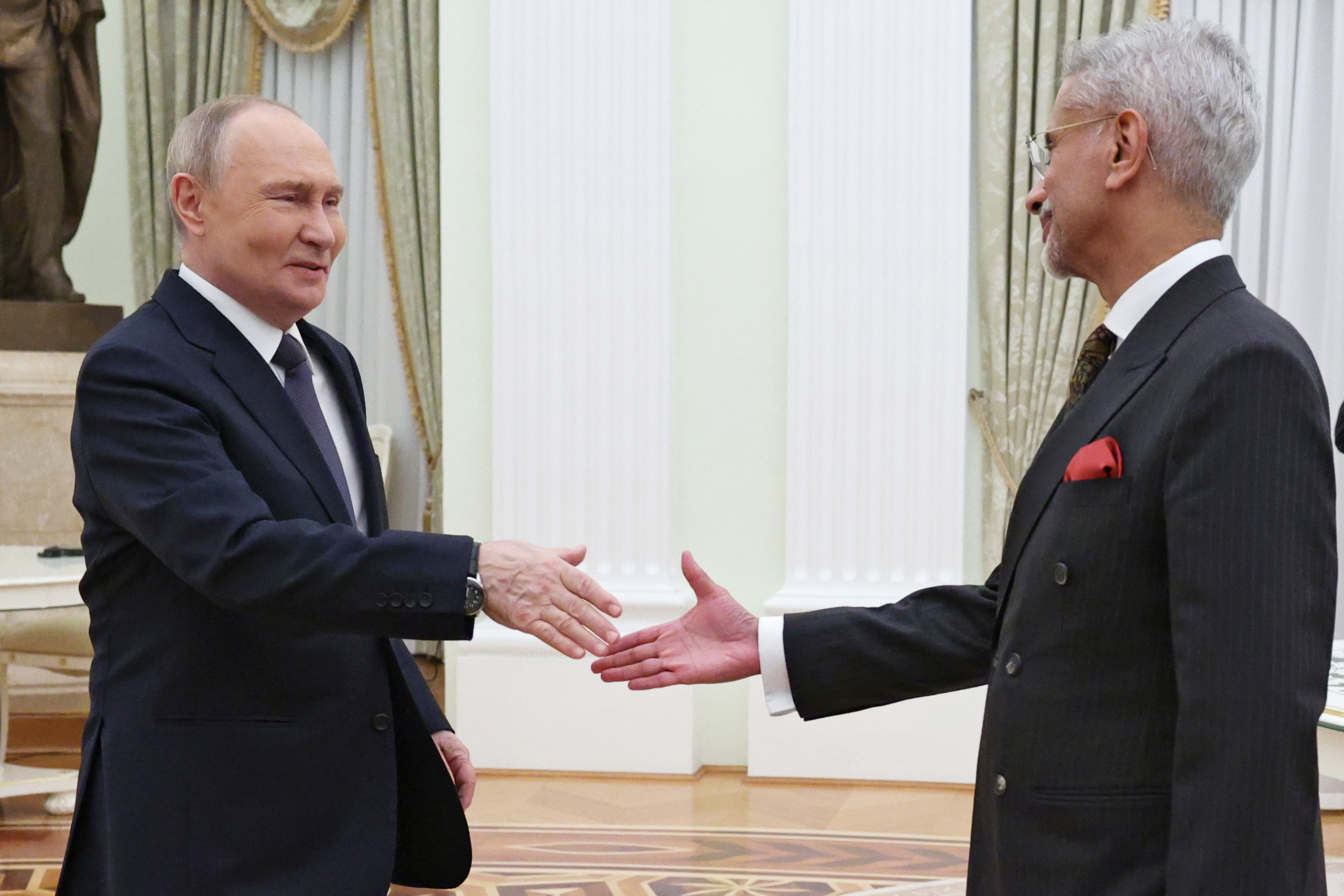 President Putin shaking hands with S Jaishankar.