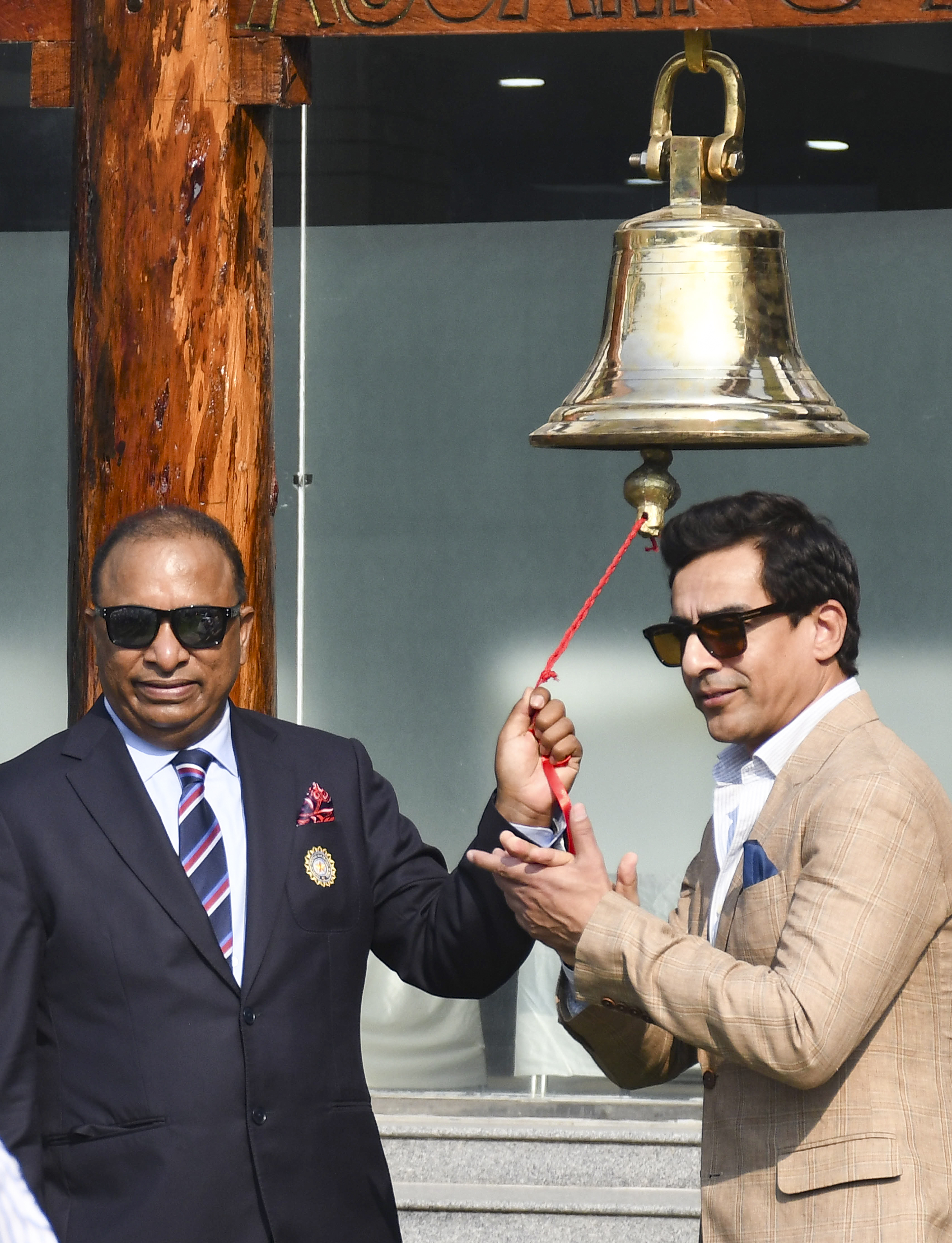 BCCI अध्यक्ष मिथुन मन्हास (दाएं) और सचिव देवजीत सैकिया बेल बजाते हुए।