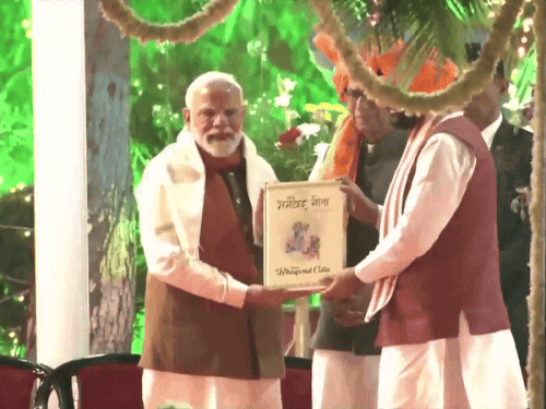 CM Nayab Saini presenting Bhagavad Gita to PM Modi