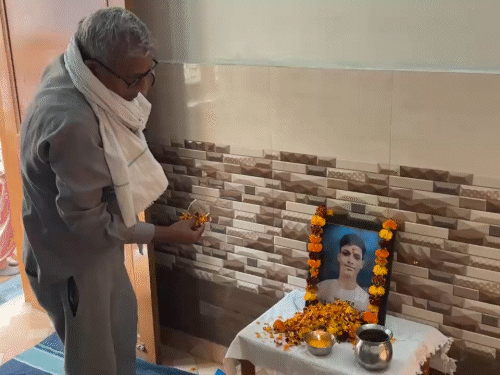बहादुरगढ़ में अमन की तेरहवीं पर उनके चित्र पर पुष्प अर्पित करता परिजन।