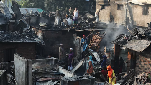 आग के कम होने के बाद घरों से बचा हुआ सामान निकालते लोग।