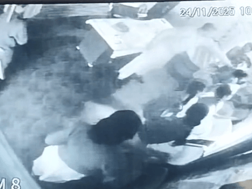 School administrator threatening another student while grabbing her neck.