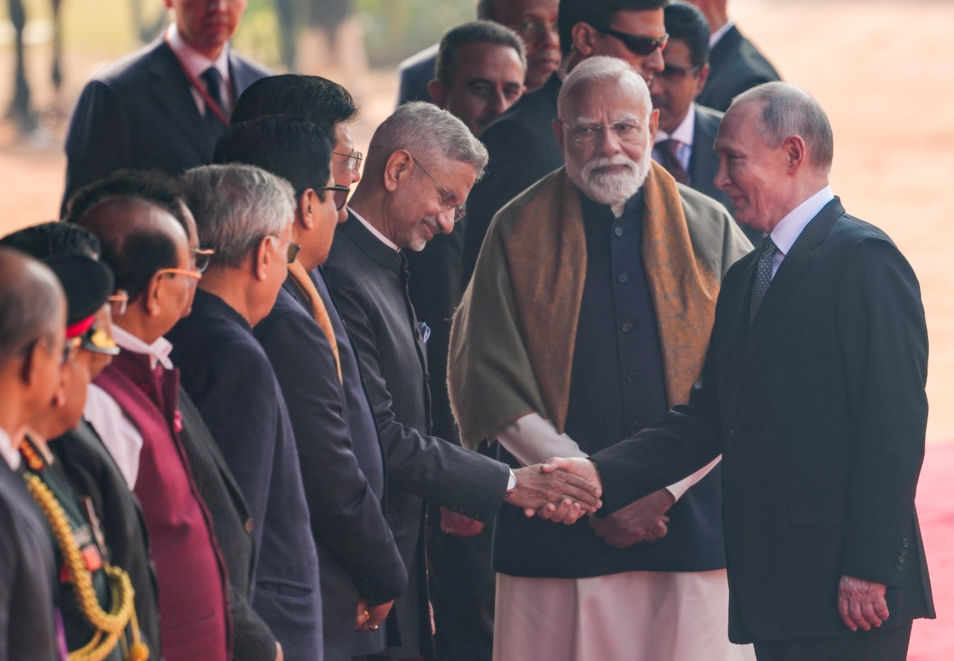 पुतिन गार्ड ऑफ ऑनर के बाद राष्ट्रपति भवन में विदेश मंत्री एस जयशंकर और दूसरे अधिकारियों से हाथ मिलाते हुए।