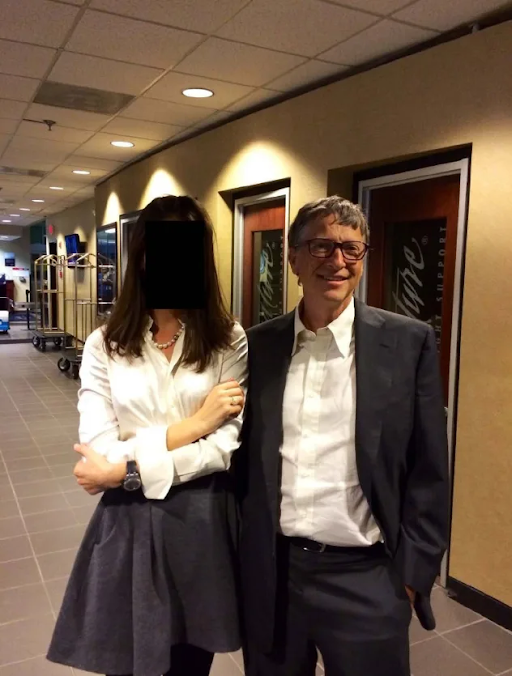 In the picture, Bill Gates, wearing a suit and boots, was seen with a woman. The woman's face has been hidden.