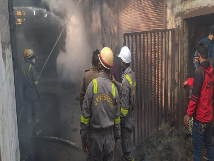 आग पर काबू पाते दमकल कर्मी।