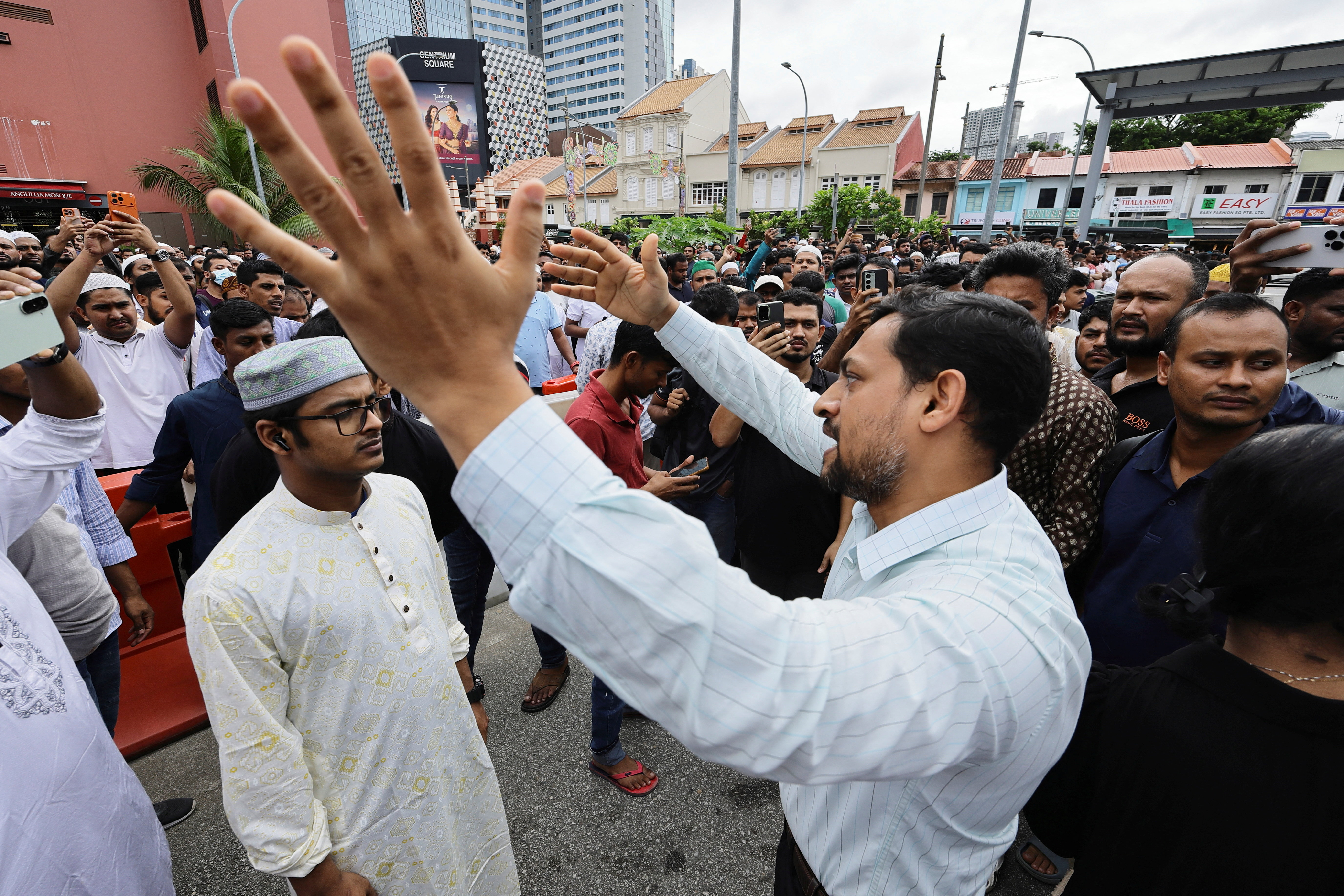 People gather outside the Angulia Mosque in Singapore to view the body of Bangladeshi student leader Sharif Usman Hadi.