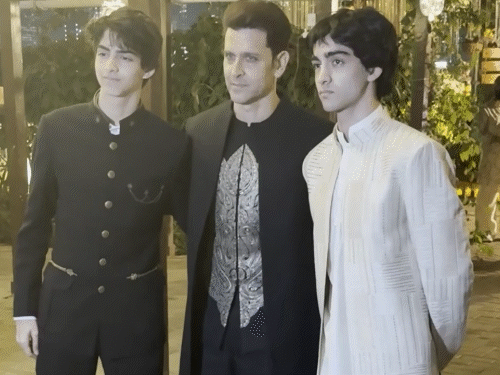 Hrithik posing for the media with both his sons.