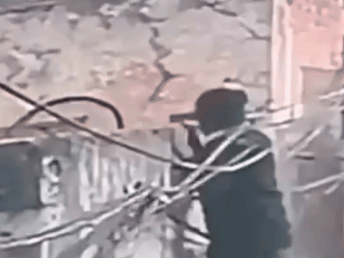 दीवार पर चढ़कर मकान में घुसता चोर।