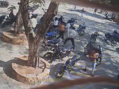 वह एक छात्र को लाठी-डंडों से पीटने लगे।