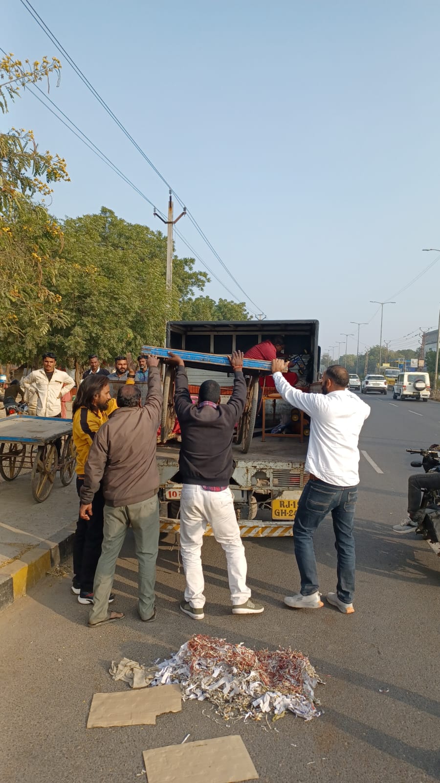 सड़क पर रखे सामान को जब्त करता निगम दस्ता।