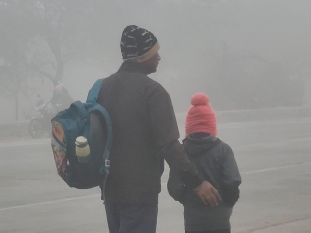 छुट्टियां के बाद ठंड में स्कूल जा रहे बच्चे