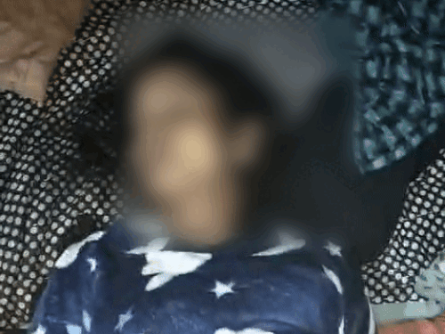 Woman's body lying on the bed.