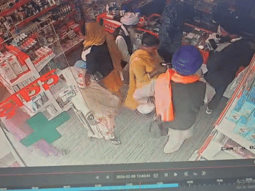 बुजुर्ग के थैले में हाथ डालती आरोपी महिला।