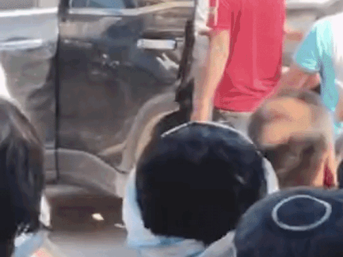 बुजुर्ग को गाड़ी में धकेलते युवक।