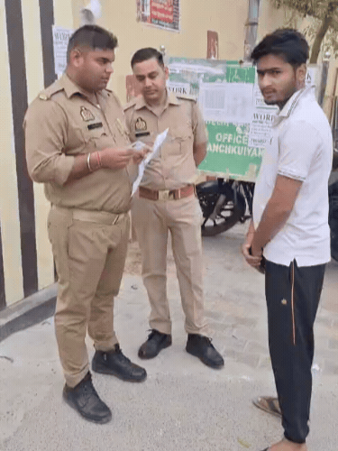 एडमिट कार्ड चेक करते पुलिसकर्मी।