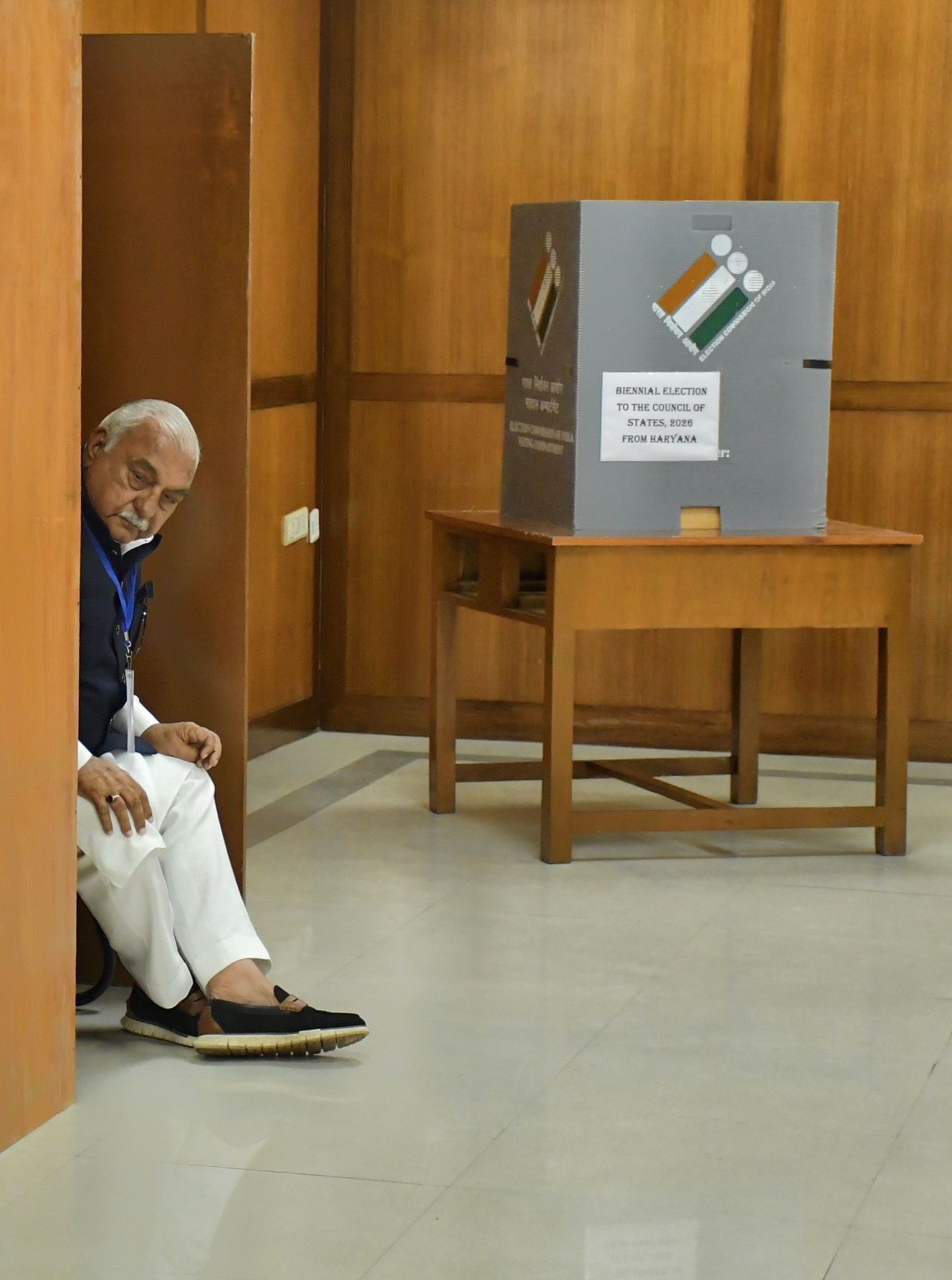 Congress leader of opposition Bhupendra Hooda was made an observer. He kept an eye on every MLA. In the picture an MLA is casting his vote. Hooda is looking the other way.
