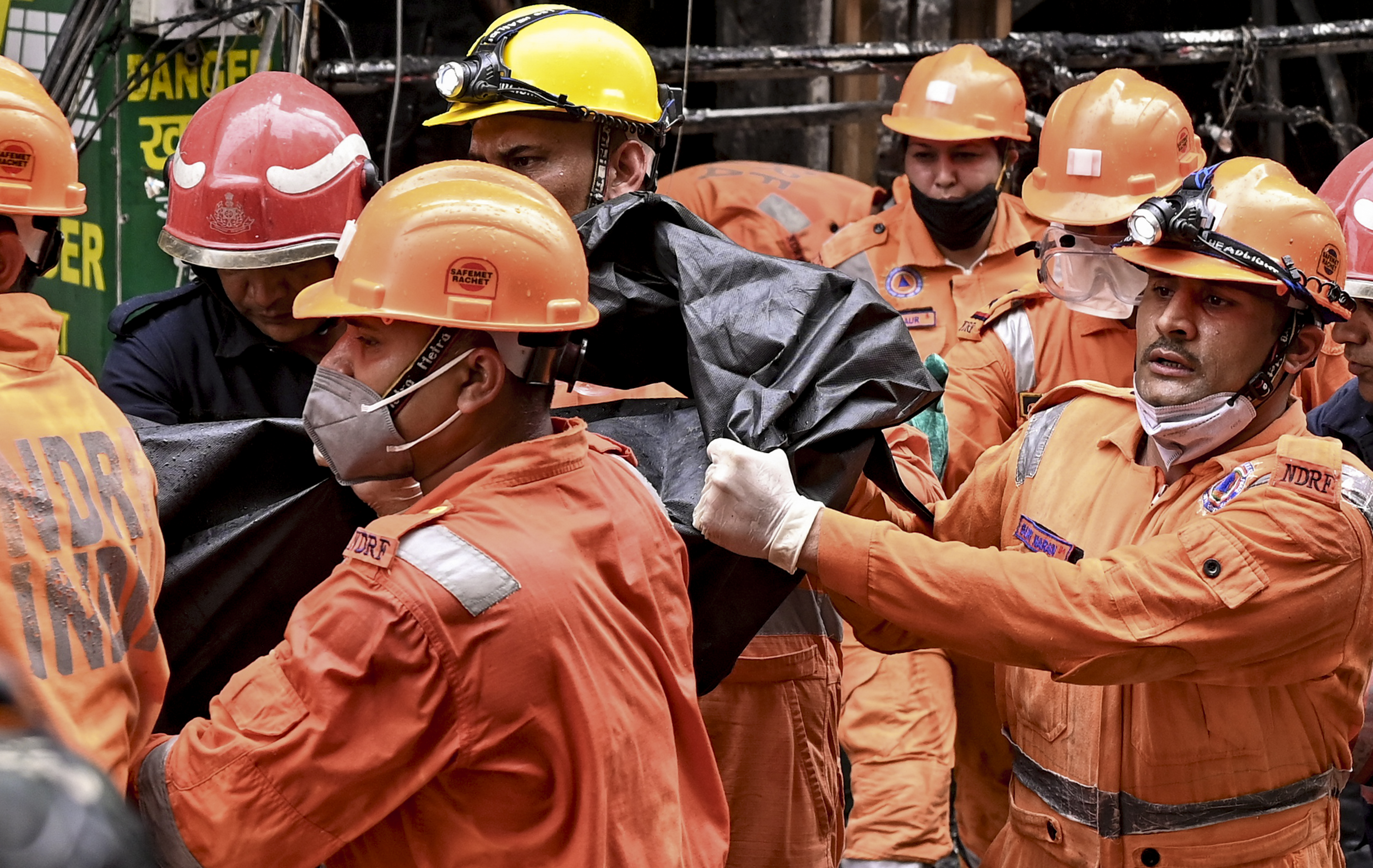 बचावकर्मियों ने बिल्डिंग के अंदर से मृतकों के शव प्लास्टिक में लपेटकर बाहर निकाले।