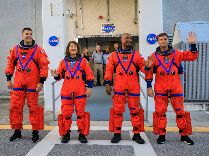 Astronauts (left to right) Jeremy Hanson, Christina Koch, Victor Glover and Reed Wiseman heading to the launch pad; Photo taken during launch day rehearsals at Kennedy Space Center.
