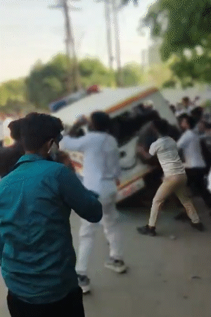 The protesting employees vandalized the police vehicle. Not only that, they also overturned it.