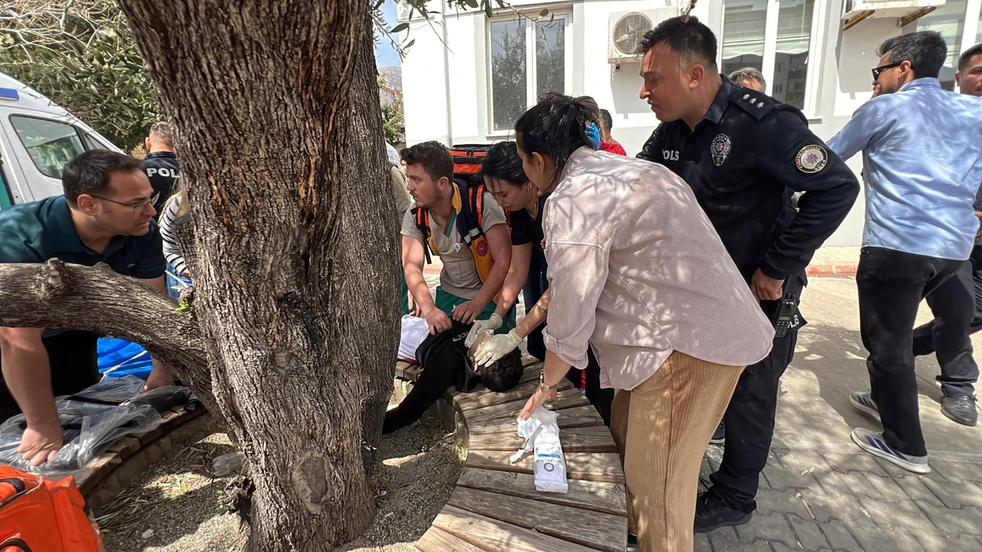 An injured student is receiving medical attention from paramedics, following a school shooting.