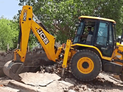 Police team demolishing the illegal encroachment