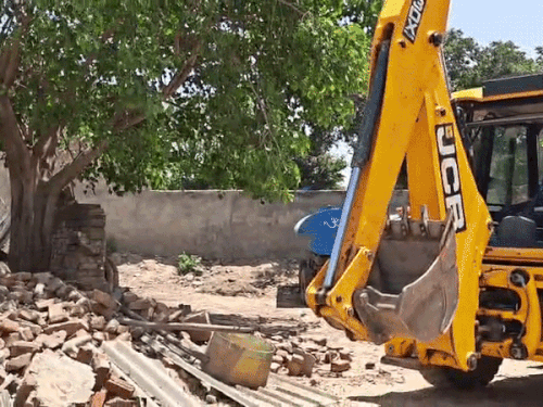 Policemen untying and driving away animals tied on the property