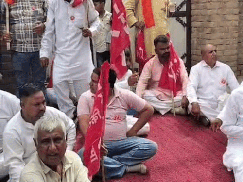 मकान के बाहर धरने पर ग्रामीण व किसान