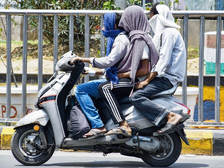 प्रयागराज में राहगीर तेज धूप से बचने के लिए खुद को ढककर बाहर निकल रहे हैं।