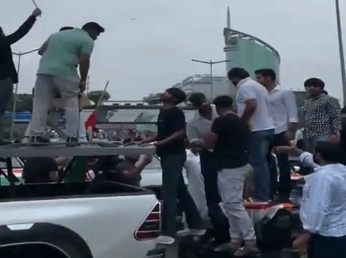 गुरुग्राम में डीएलएफ साइबर सिटी की मुख्य सड़क पर महंगी गाड़ी खड़ी करके वीडियो बना रहे युवक।