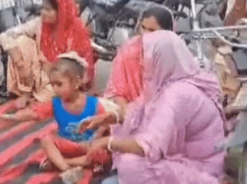 बच्चे के साथ जाम लगाकर सड़क पर बैठी महिलाएं।