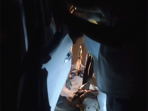 Bodies being removed from the car.